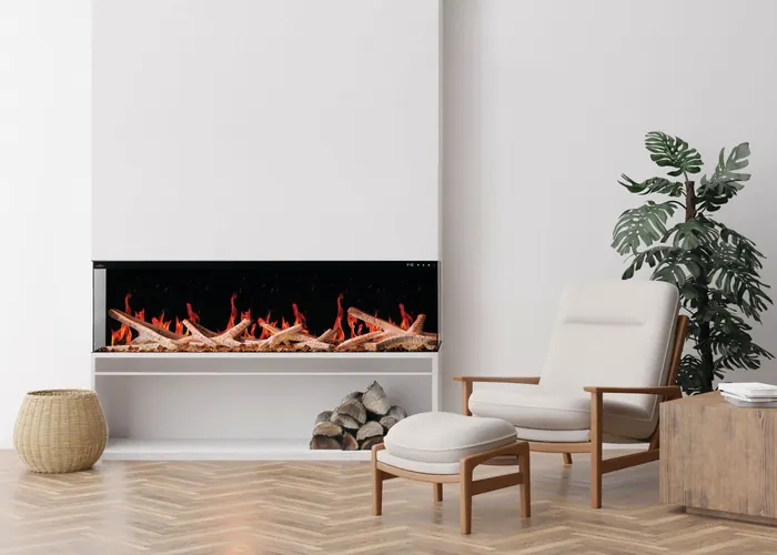 Napoleon Luminex 65 LCD electric fireplace installed three-sided in a white wall, with a lounge chair and ottoman on a herringbone floor